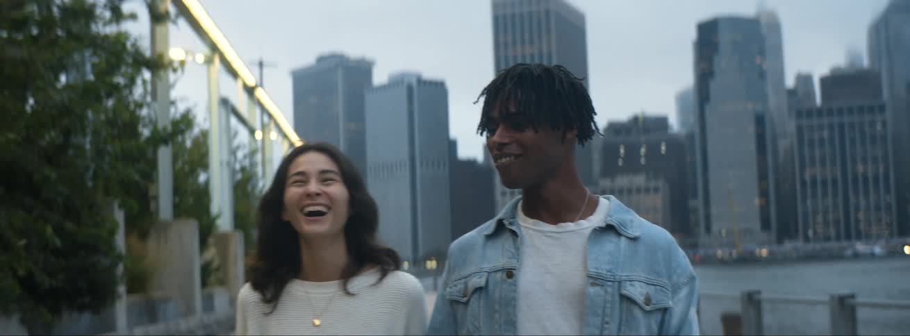 Two people walking outside talking and laughing