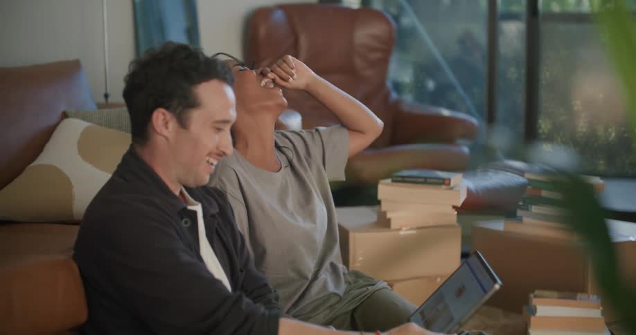 Two people sitting on a couch talking
