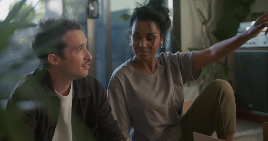 A man and woman talk together in the room