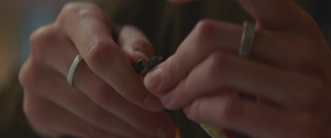 Hands holding and unpicking frayed ends with a tool