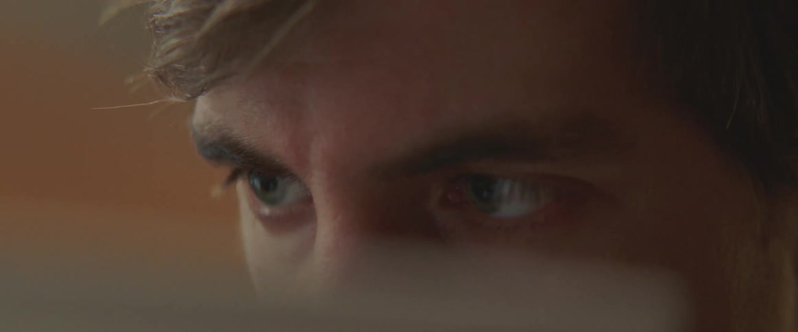 A close up of a man looking at a screen