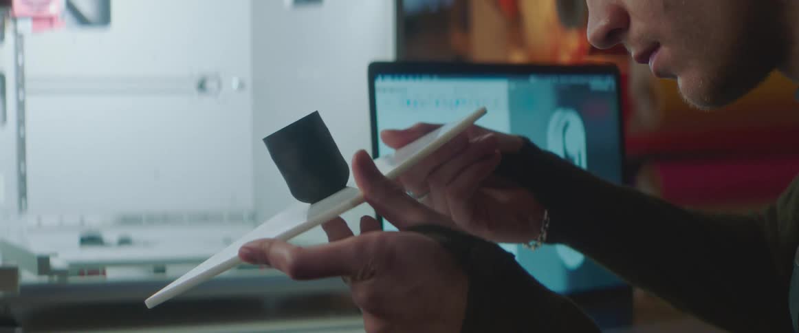 A male engineer examining a plastic object in the workplace