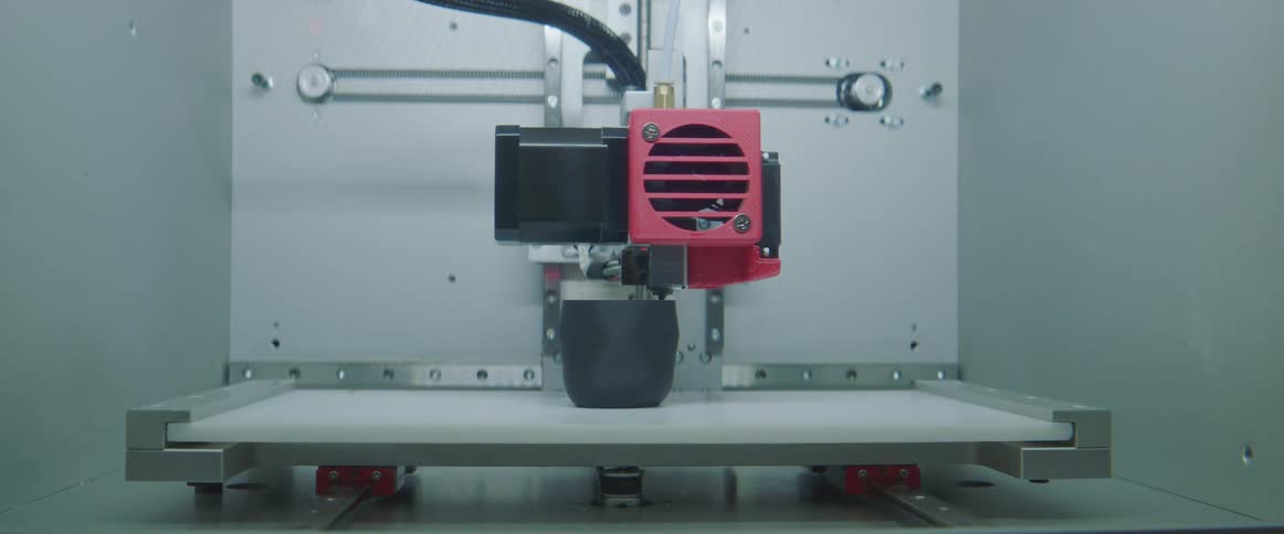 3d printer prints dark gray object