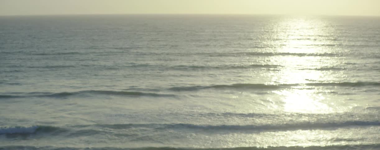 Aerial view of some water reflecting a setting sun
