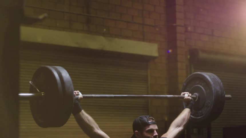 A man is deadlifting in a gym