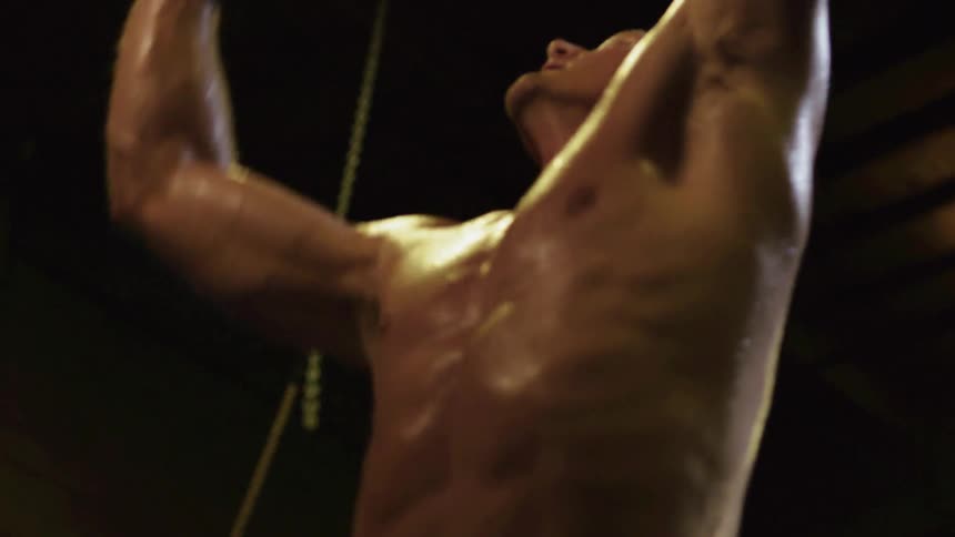 A man is sweating as he works out in a gym