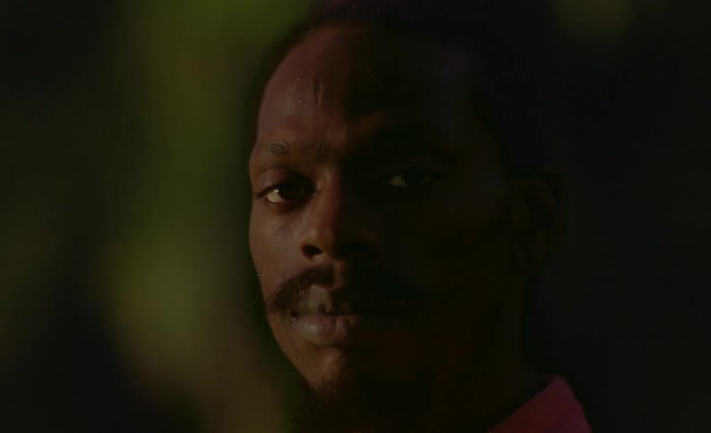 Man looks around while posing