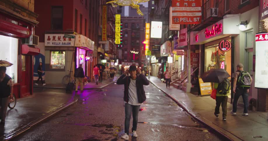 People are walking in a downtown city at night