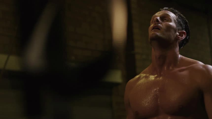 A man takes a few breaths before continuing his exercising