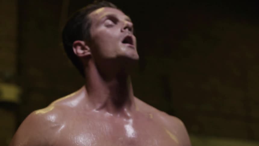 A man is sweating in a gym as he works out