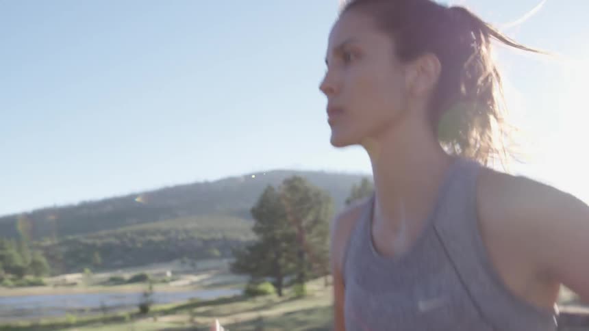 Woman jogging across a bridge