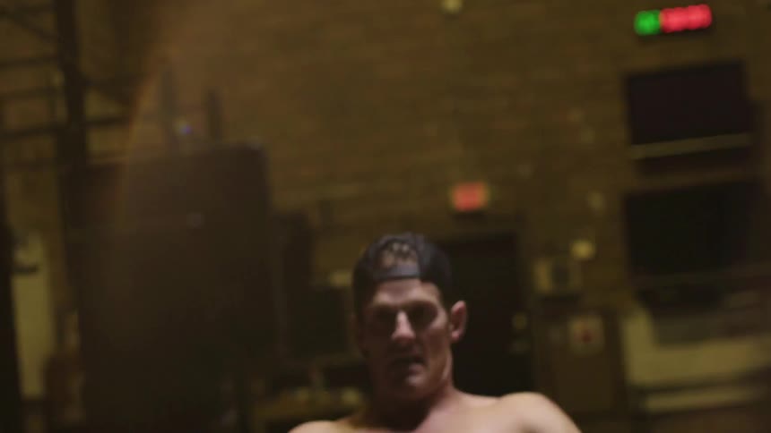 A man exercises on the rowing machine at the gym