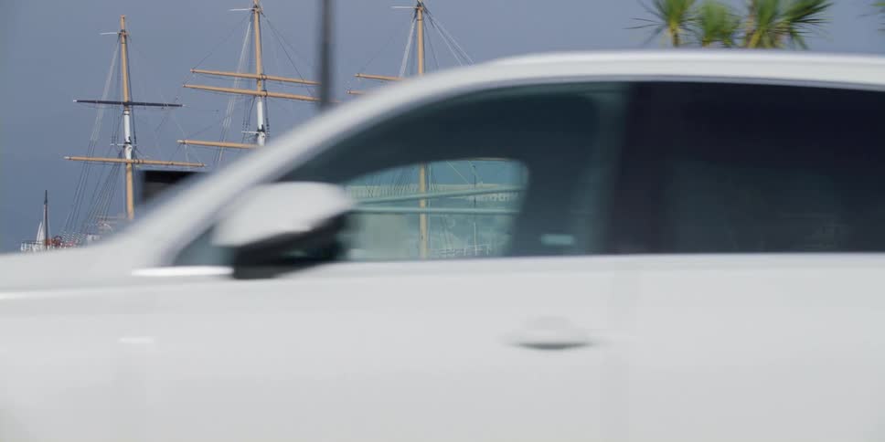 Cars and pedestrians are moving through a city