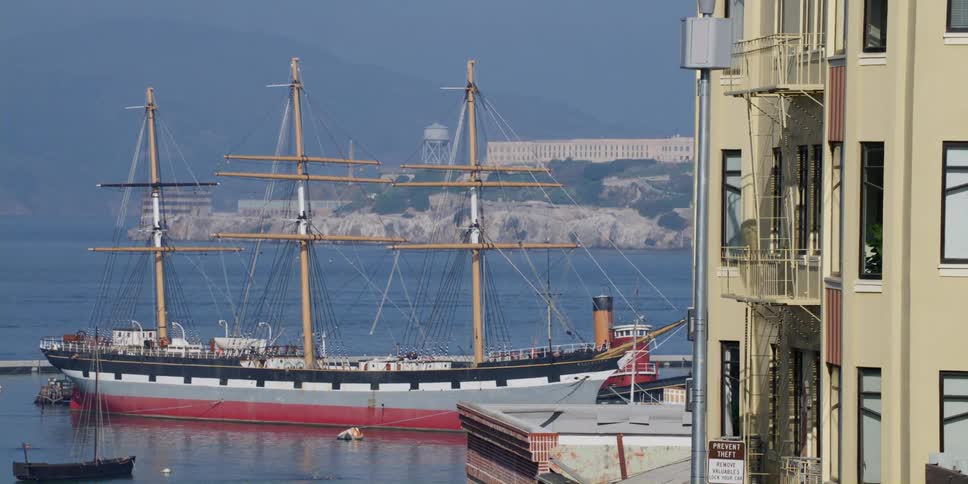 A large ship is docked in the harbor