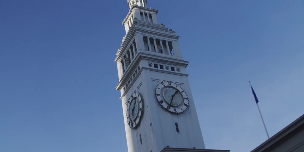 A clock tower sits on a steeple over downtown