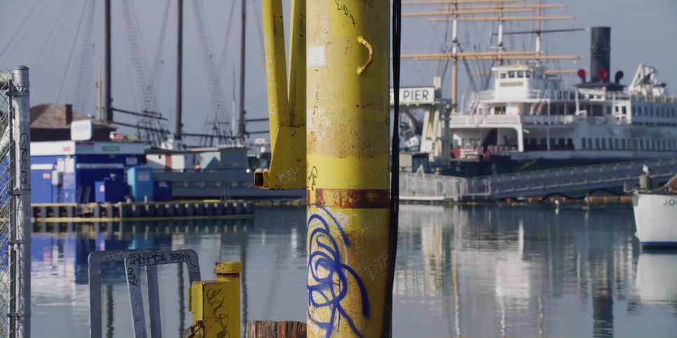 Boats are parked at a pier on the ocean