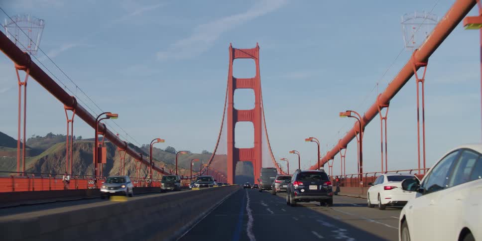 Driving through golden gate bridge with mountains in the background