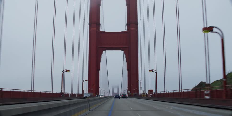 Heavy traffic passes down a multi lane suspension bridge