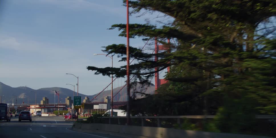 Traffic merges while heading onto a bridge