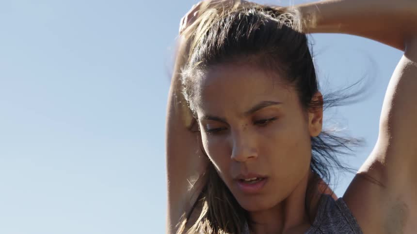 Woman stretching her arm on windy day