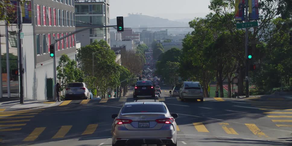 Cars driving down a city street