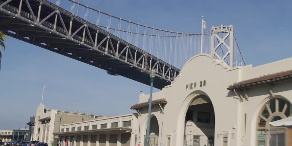 Suspension bridge seen from moving vehicle on city road