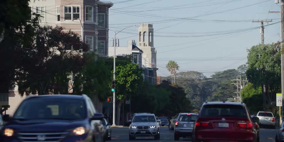 Traffic moves around the neighborhood street