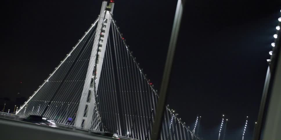 Cars travel with traffic over the bridge