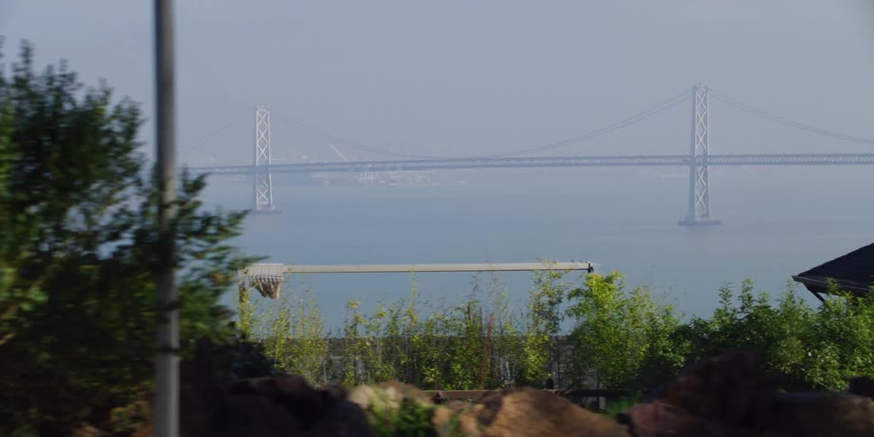 A public trail along the coast runs parallel to a bridge and pier
