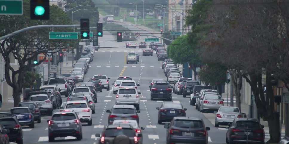 Cars driving down a busy city street