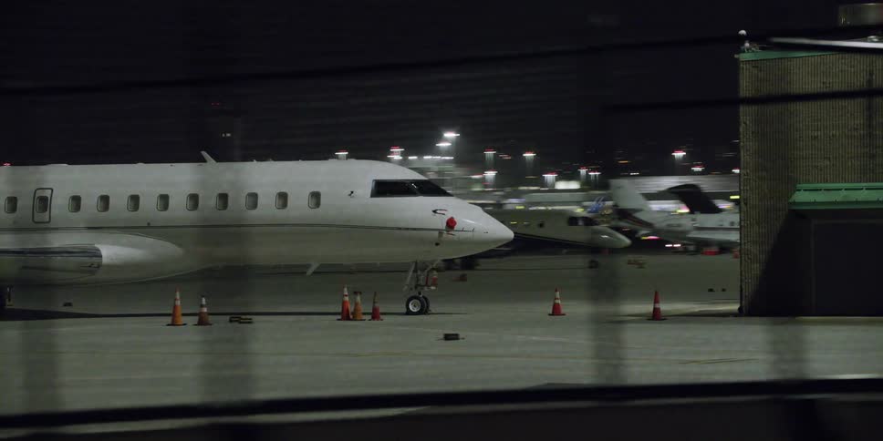 The planes are parked near the hangars