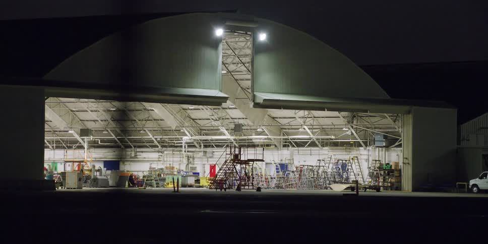 The hanger is lit up inside at night