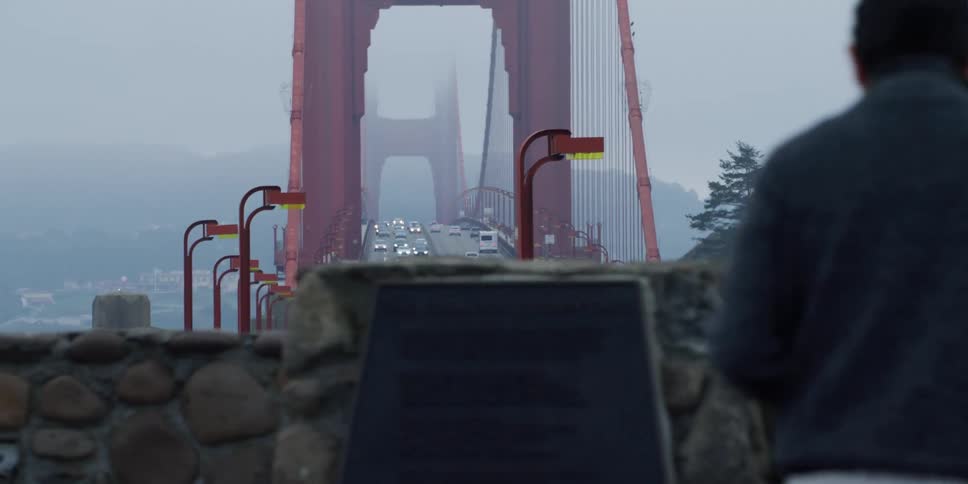 Traffic crossing over the golden gate bridge at morning under the mist