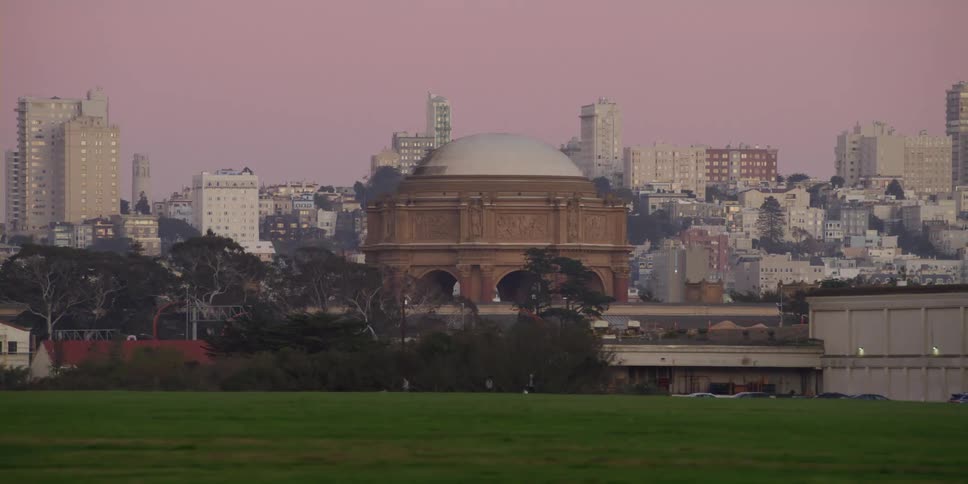 Cars are driving on the outskirts of a city