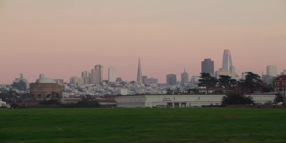 City skyline with high rise buildings seen from park at dusk
