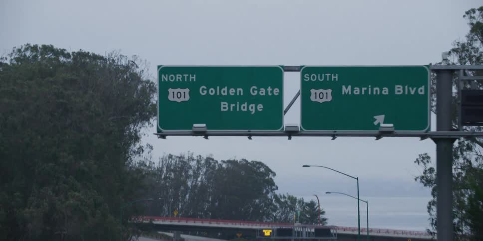 Passing under the green highway sign close to the golden gate bridge