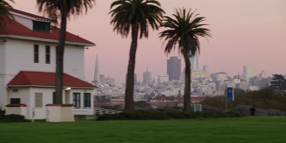 Driving on a neighborhood in front of the san francisco skyline at sunset