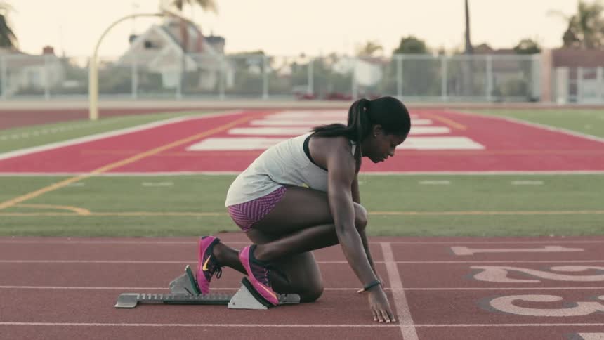 Woman setting up on a track and sprinting