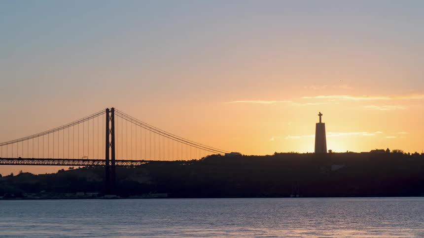 Time lapse view of a river and bridge is displayed