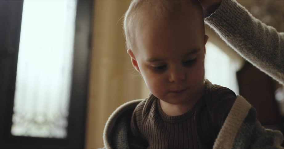 Mother strokes child as boy plays