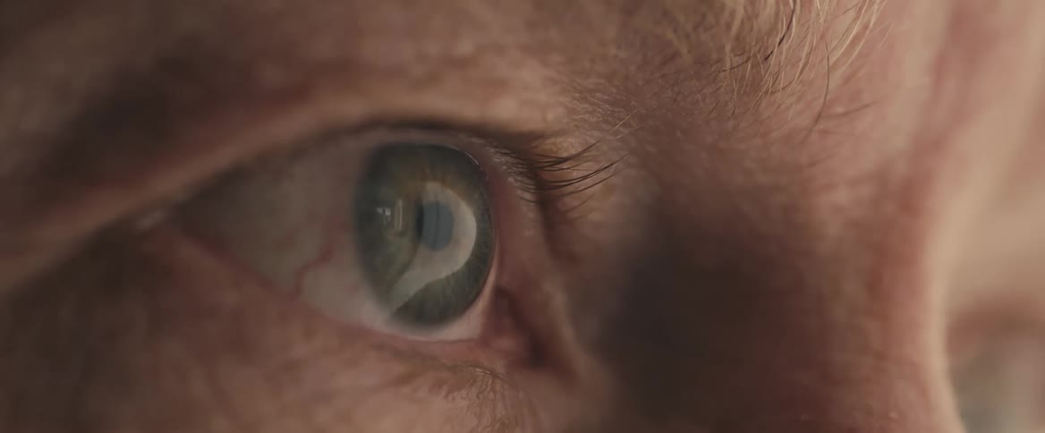 A man stares straight ahead without blinking