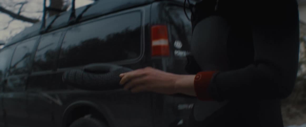 A man putting on gloves outside