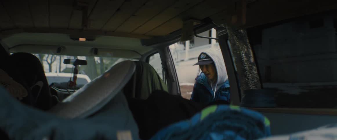 A person is climbing into a vehicle in winter