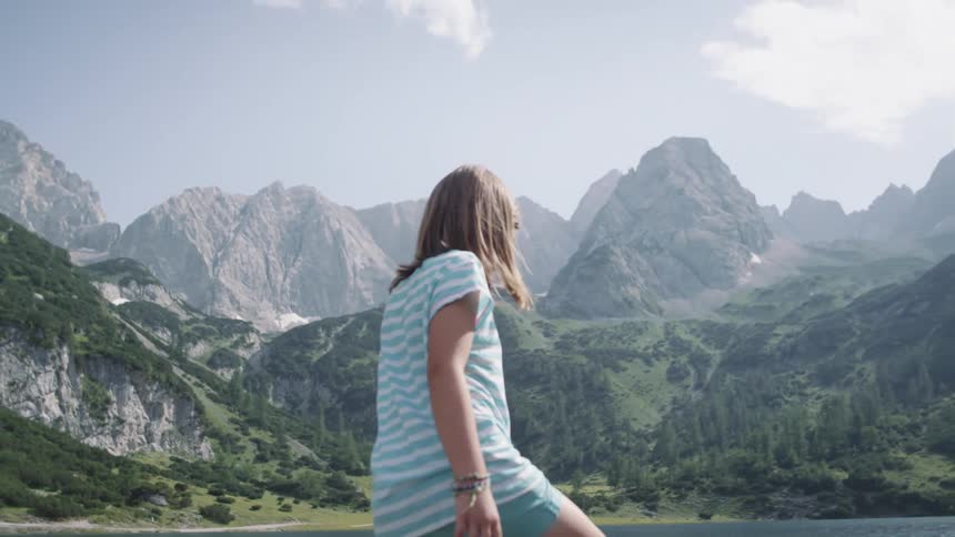A child is walking in a mountainous area