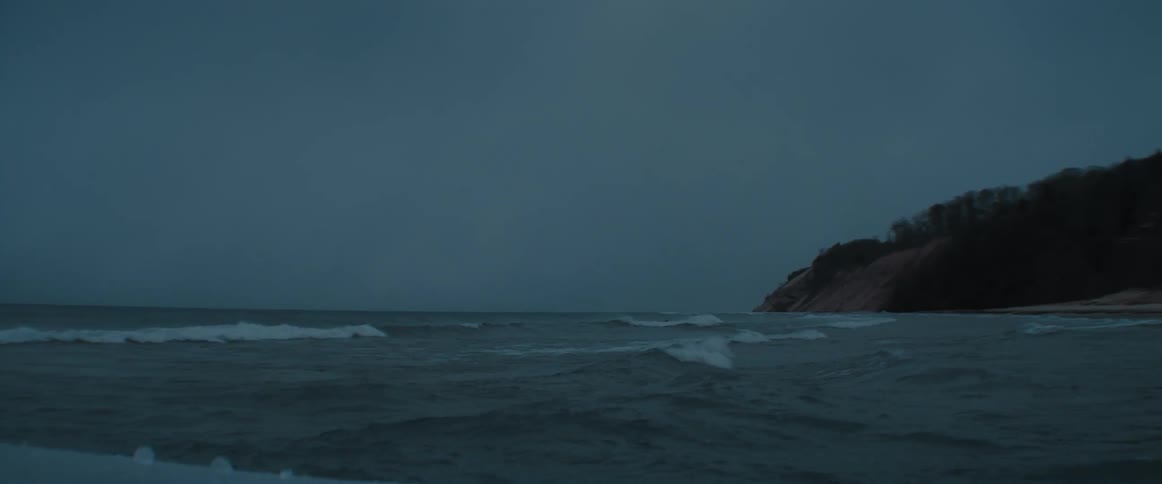 Waves are moving in the ocean at dusk