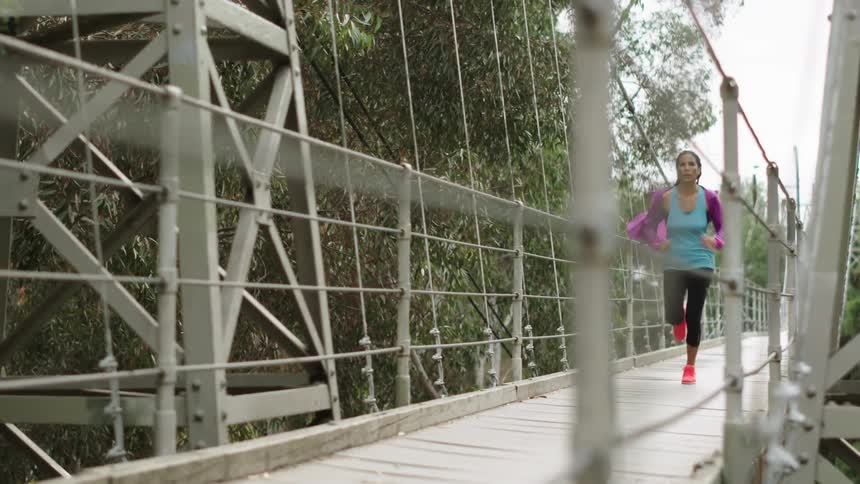 A jogger crossing a bridge
