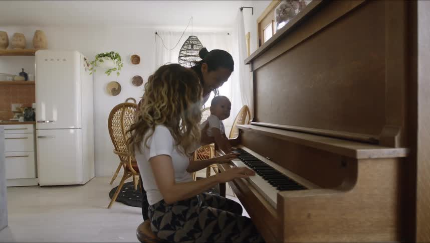 A family playing on a piano
