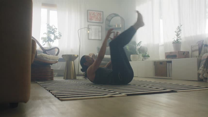 A man is working out in the living room