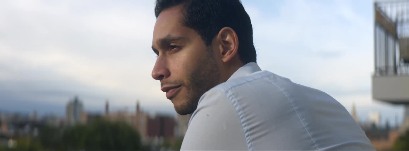 A man stands on his terrace looking outside