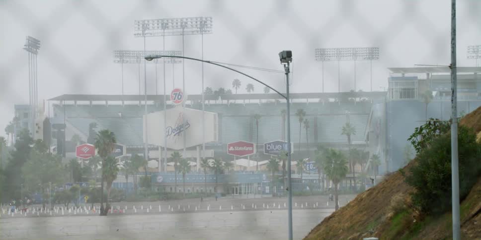 People walking across a lot towards dodger stadium